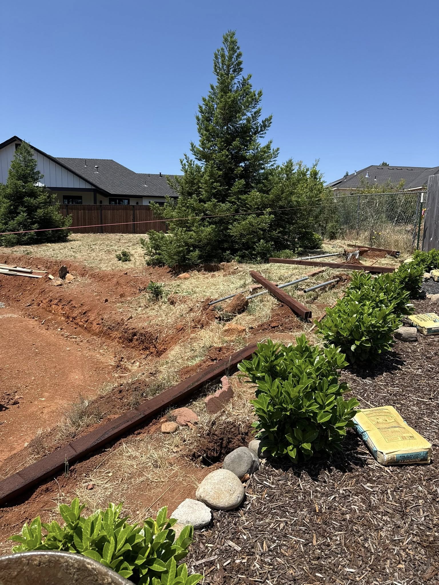 Backyard slope before retaining wall and rock finish