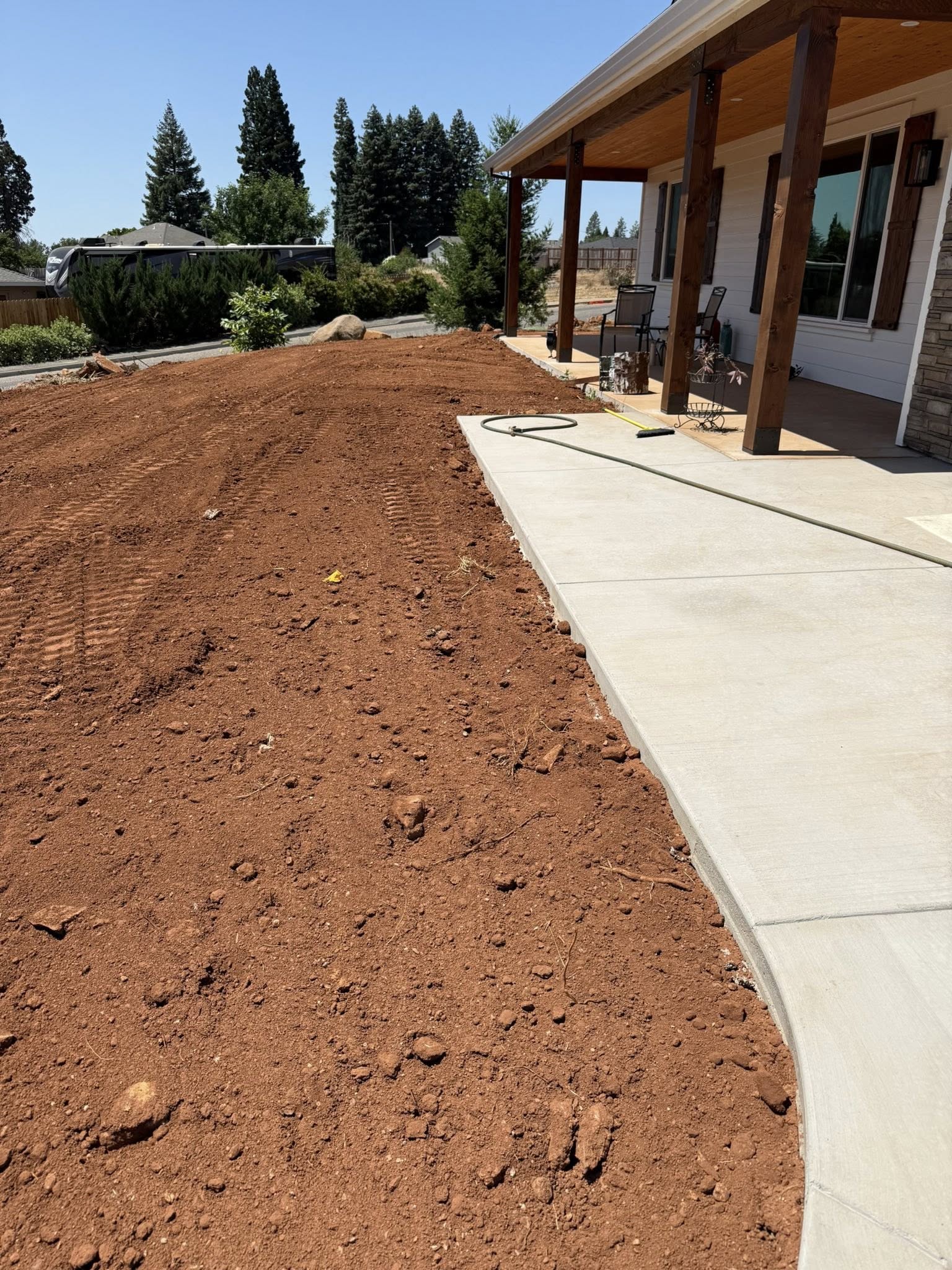 Side yard before rock path, edging, and lawn installation